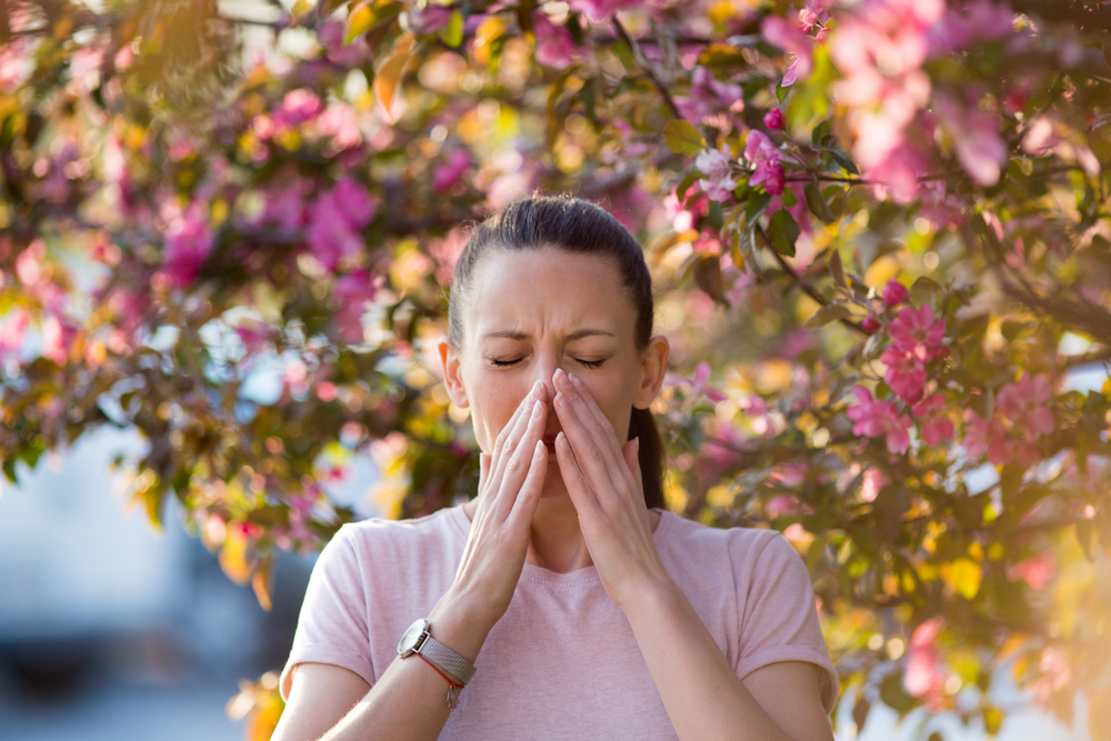 woman with allergies sneezing.